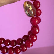 INCANTEVOLE -  Chocker flessibile contrarié  giada ruby sfaccettata con  terminali dorati Agata