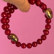 INCANTEVOLE -  Chocker flessibile contrarié  giada ruby sfaccettata con  terminali dorati Agata