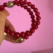 INCANTEVOLE -  Chocker flessibile contrarié  giada ruby sfaccettata con  terminali dorati Agata