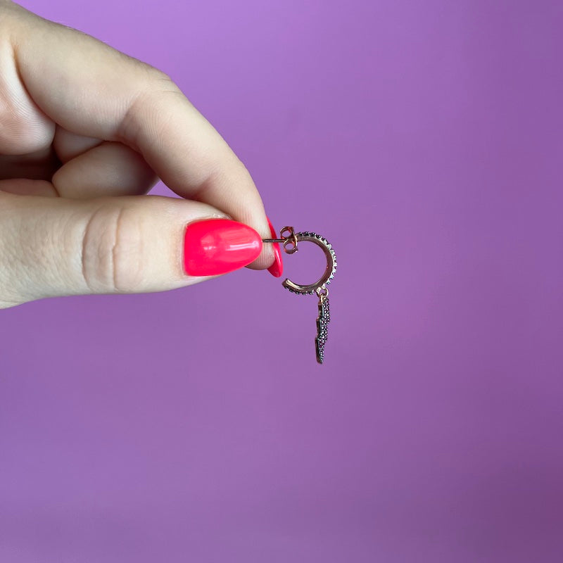 Coppia di orecchini con fulmine pendente e zirconi fucsia